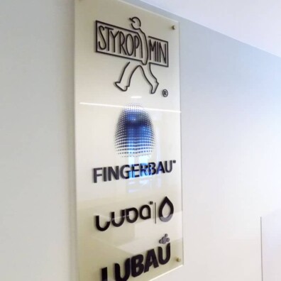 litery przestrzenne logo z pleksi na tablicy prezentacyjnej